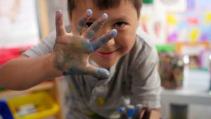 Child with paint on fingers
