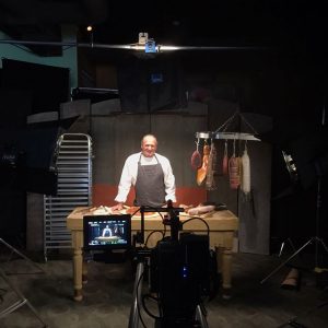 Filming butcher making pizza