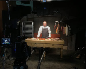 Butcher making pizza