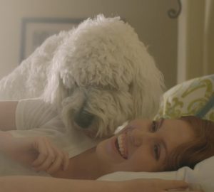 Dog waking up woman