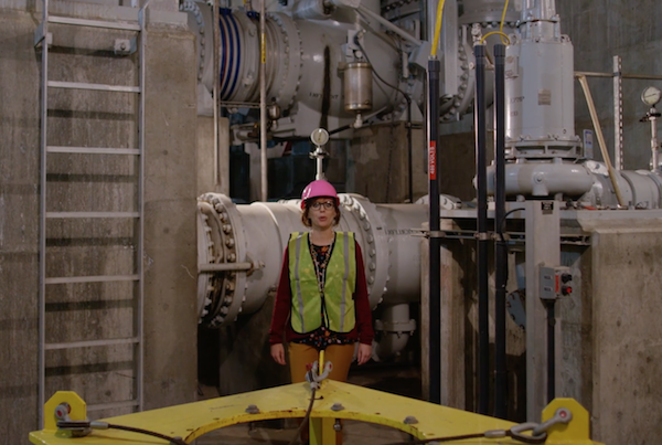 Spokesperson next to machinery