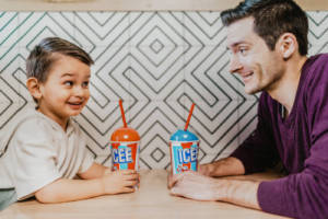 A boy and his father drinking ICEEs