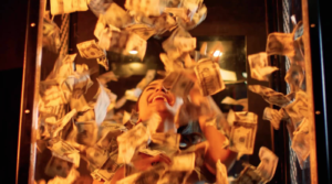 Woman in cube surrounded by flying cash
