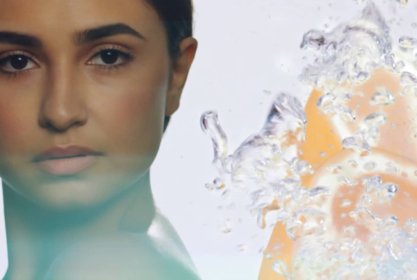 A woman's face next to fruit in water