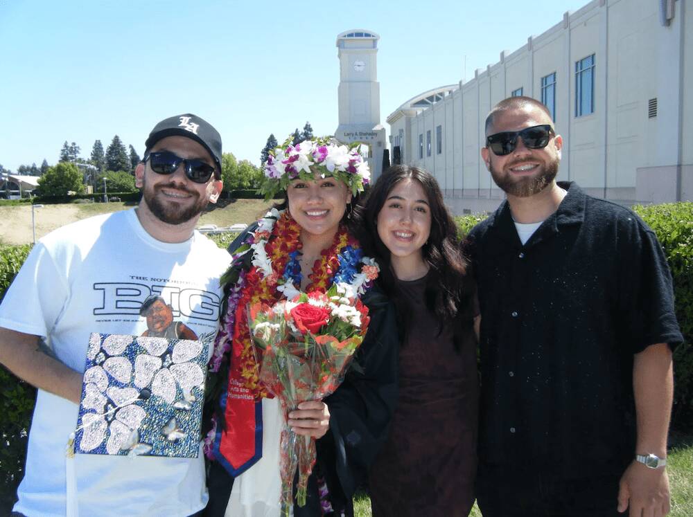 Jordan celebrating a graduation milestone surrounded by family, symbolizing the start of a journey in the video production industry – teamwork and creativity in focus.