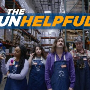 A group of disinterested employees in a warehouse setting wearing blue aprons, standing under a bold sign that reads 'THE UNHELPFULS'.
