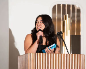 Jordan Singh giving her Rising Star Award acceptance speech at the podium during the AAF Fresno Honors Luncheon.